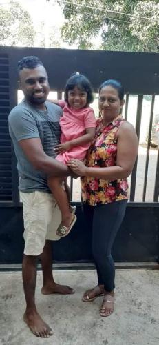 a man and a woman holding a little girl at The City Tourist Hotel in Anuradhapura
