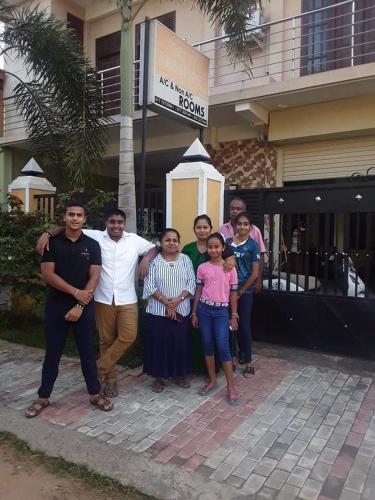 a group of people standing in front of a building at The City Tourist Hotel in Anuradhapura