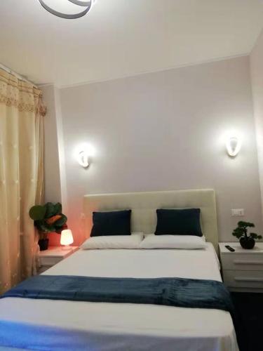 a bedroom with a large white bed with blue sheets at Xixi B&B in Mestre
