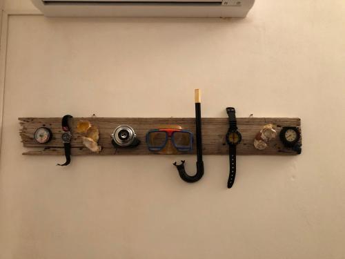 a wooden shelf with various tools on a wall at Villa Mariza in Scopello