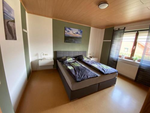 a bedroom with a bed in a room with a window at Ferienwohnung Jenny Edersee in Edersee