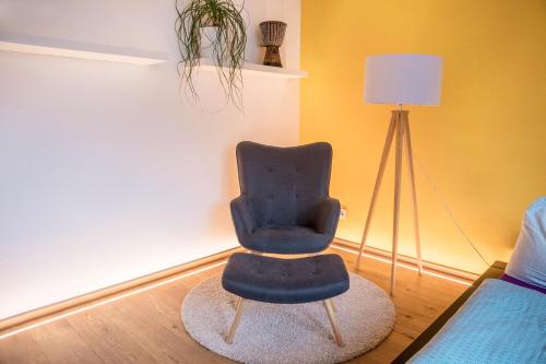 a blue chair sitting in a room next to a lamp at Lieblingsplatzl in Naturno