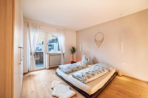a bedroom with a large bed and a window at Lieblingsplatzl in Naturno