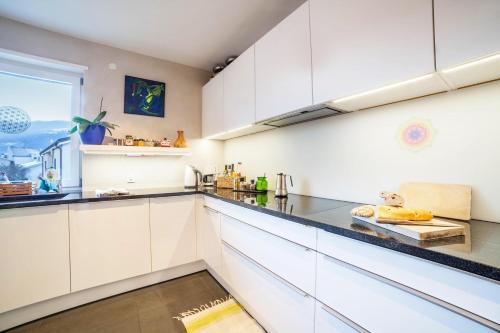 a kitchen with white cabinets and a window at Lieblingsplatzl in Naturno