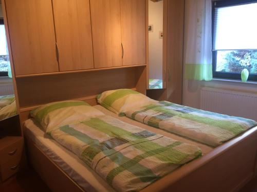 two beds sitting in a room with a window at Ferienwohnung Hergenröder in Riedenberg