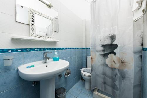 a bathroom with a sink and a toilet at Garden Studios Thassos Town in Limenas