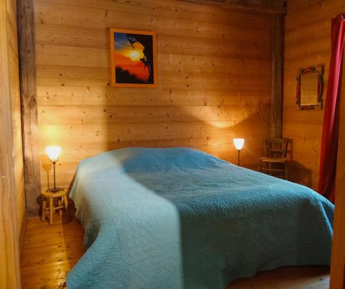 a bedroom with a bed in a wooden room at Chalet Du Vieux Guide in Samoëns