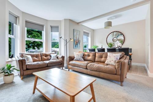 a living room with two couches and a coffee table at Quay House, North Coast 6 bedroom holiday home in Ballycastle