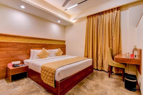 a hotel room with a bed and a desk at Zip By Spree Hotels Brookefield in Bengaluru