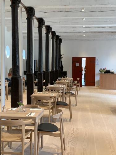 a row of tables and chairs in a room at Schackenborg Slotskro in Tønder