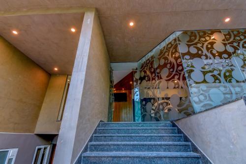 a staircase leading to a building with a mural on the wall at Zip By Spree Hotels Brookefield in Bengaluru