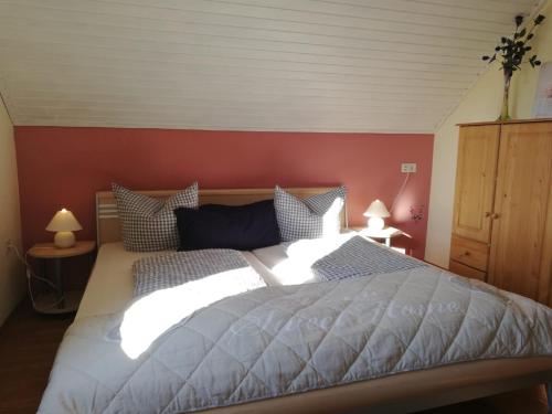 弗拉敦根的住宿－Ferienwohnung Haus Silvia，一间卧室设有一张带红色墙壁的大床