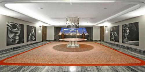a dining room with a table and a chandelier at Crowne Plaza Bursa Convention Center & Thermal Spa by IHG in Bursa