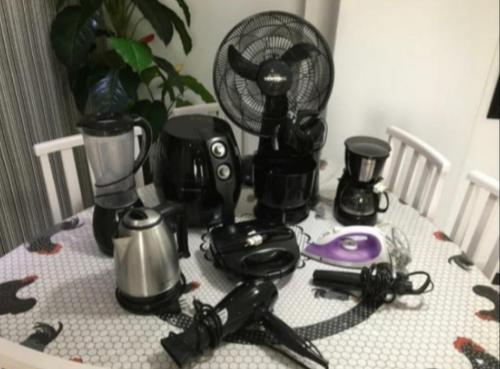 a table with a blender and other appliances on it at Apartamento Praia Central in Balneário Camboriú