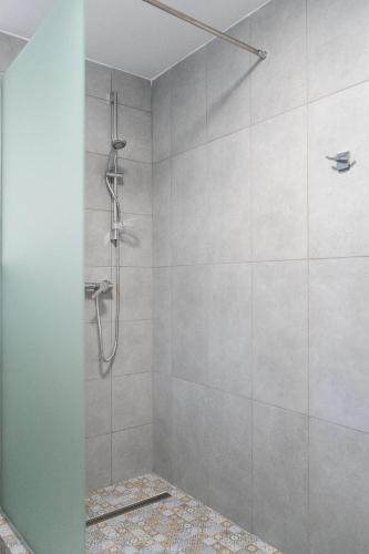 a bathroom with a shower with a glass door at Apartments Eibenthal in Eibenthal