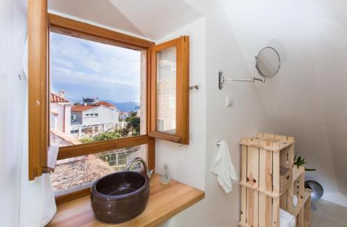 a bathroom with a sink and a window at Apartment Art Dubrovnik in Dubrovnik