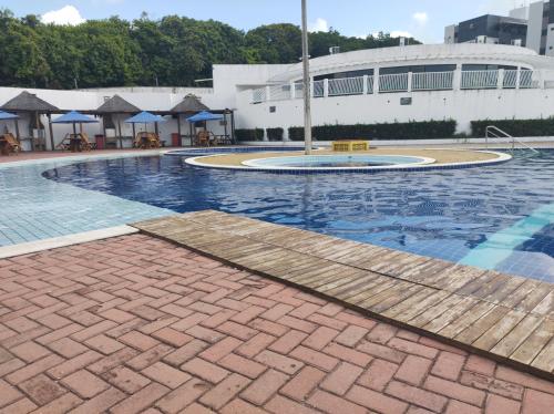 a swimming pool in front of a building at Condomínio encantador próximo a praia , 3 quartos. in João Pessoa