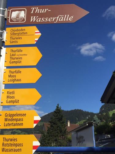a street sign with many signs pointing in different directions at Hotel Sternen Unterwasser in Unterwasser