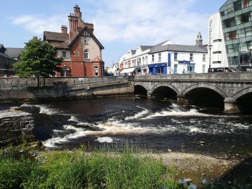 a bridge over a river in a city at Lilac Manor in Sligo