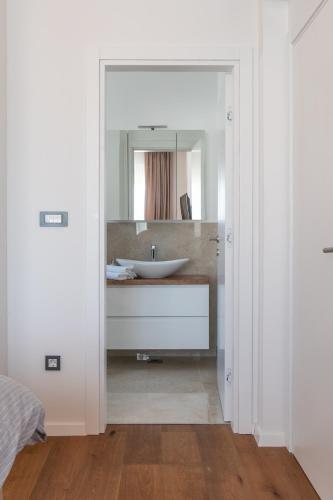 a bathroom with a sink and a mirror at Villa DEA - Luxus Ferienhaus in Kroatien mit beheizten Pool Vrsi-Mulo bei Zadar in Vrsi