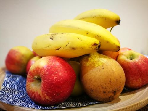 a pile of apples and bananas on a plate at Hotel Kristína in Dubnica nad Váhom