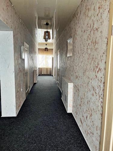 an empty hallway in an office building with a hallway at Viktan Hotel in Bukovel