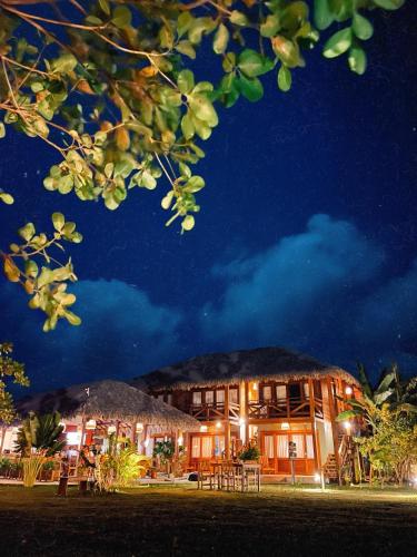 a resort with a building at night at VILA ATY LODGE in Atins
