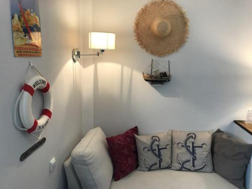 a living room with a white couch and a lamp at Bergland Hotel - Adults only in Salzburg