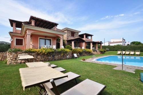 een villa met een zwembad en een huis bij Le Dimore di Nettuno - Happy Rentals in Olbia
