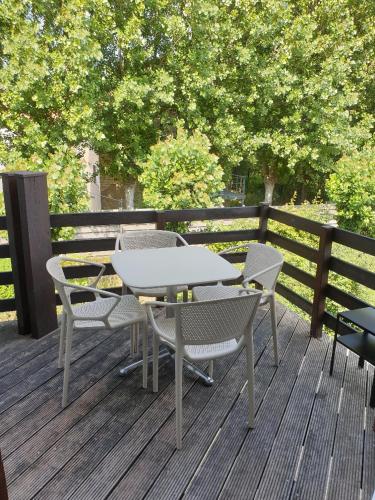 a table and chairs on a wooden deck at Duinengolf 5 in Middelkerke