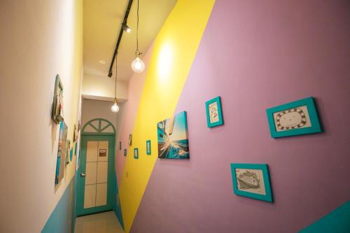 a hallway with colorful walls and a door at Lamanca in Hualien City