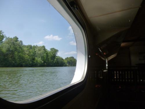 a view of a river from a train window at Péniche Daphné's in Auvers-sur-Oise