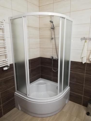 a shower with a glass enclosure in a bathroom at Villa Dobry Adres in Dziemiany