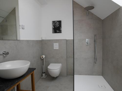 a bathroom with a sink and a toilet and a shower at Hotel Belmur in Murska Sobota