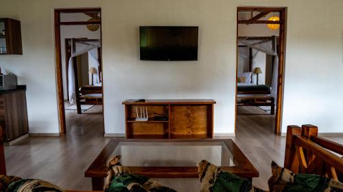 a living room with a couch and a tv at Yellowwood House in Nakuru