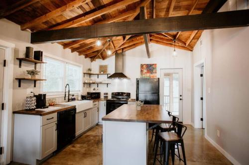 a kitchen with white walls and wooden ceilings at The Turquoise Door Modern Rustic in Town of Lexington in Lexington