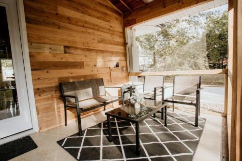a screened in porch with two chairs and a table at The Turquoise Door Modern Rustic in Town of Lexington in Lexington