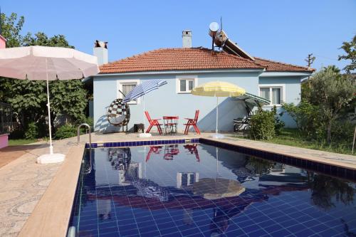 a house with a swimming pool in front of a house at Villa Misli - Heart of Dalyan and Newly Renovated in Dalyan