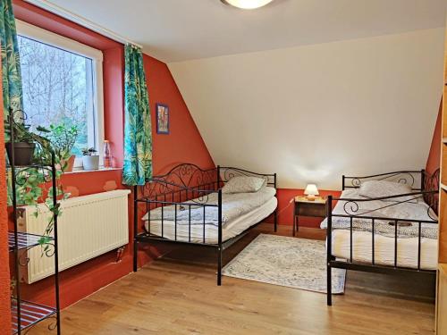 a bedroom with two bunk beds and a window at Agroturystyka DoWoli in Świeradów-Zdrój