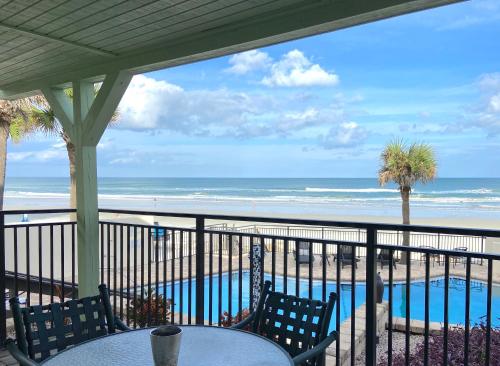 a view of the beach from the balcony of a beach house at Organic Beach Retreat in Daytona Beach