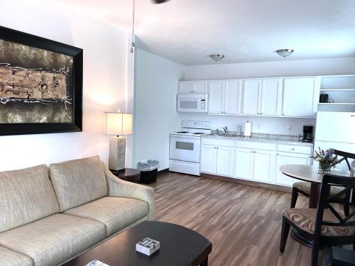 a living room with a couch and a kitchen at Organic Beach Retreat in Daytona Beach