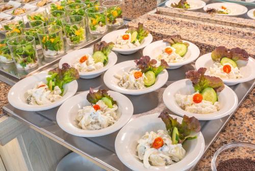 a buffet with many plates of food on a table at JS Miramar in Can Picafort