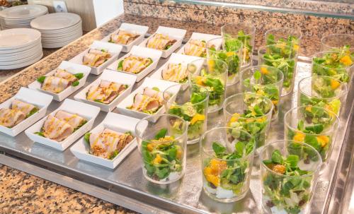 a buffet of sandwiches and salads in glass cups at JS Miramar in Can Picafort