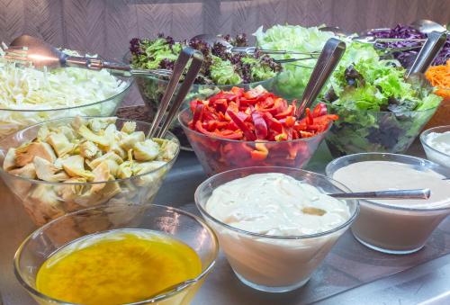 a table with bowls of different types of food at JS Miramar in Can Picafort