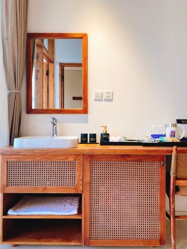 a bathroom with a sink and a mirror at 22Land Hotel & Residence in Hanoi