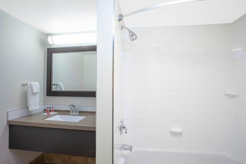 a bathroom with a sink and a shower at Quality Inn & Conference Centre Kingston Central in Kingston