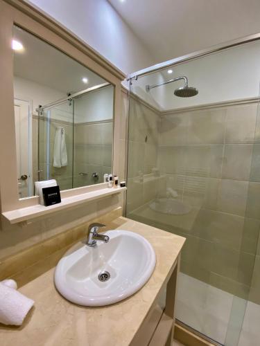 a bathroom with a sink and a shower at Serena Hotel - Punta del Este - Unico sobre la Playa in Punta del Este