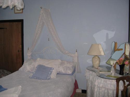 a bedroom with a bed and a table with a lamp at East Farm House B&B in Abbotsbury