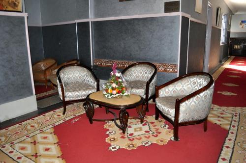 a room with chairs and a table with a christmas tree on it at Hôtel Transatlantique in Casablanca