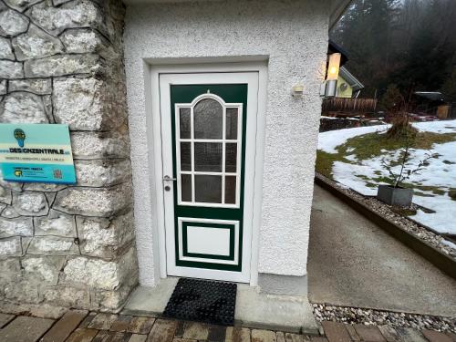 a door to a house with a stone wall at Apartment Ausseerland - willkommen bei Freunden in Bad Aussee